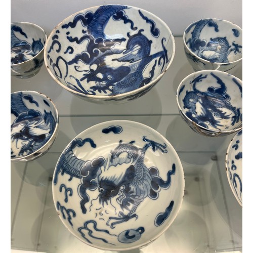 1229 - Selection of Antique Chinese blue and white dragon design cups and saucers, matching bowl, one other... 