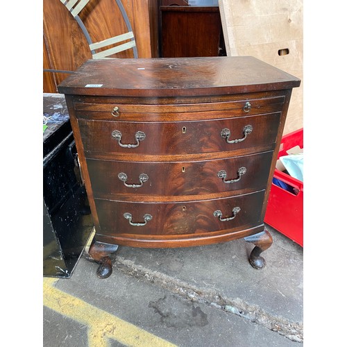 1031 - Reproduction bow front chest of drawers with pull out writing area.