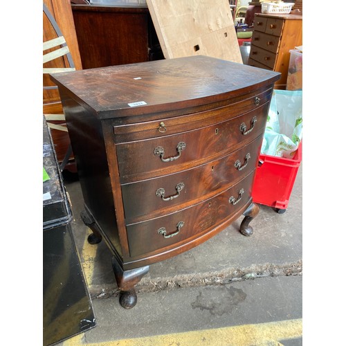 1031 - Reproduction bow front chest of drawers with pull out writing area.