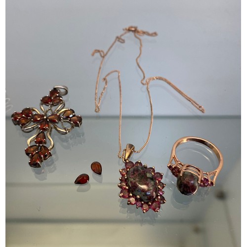 746A - Collection of silver jewellery; Three silver rings, A Pair of blue stone earrings, Garnet stone cruc... 