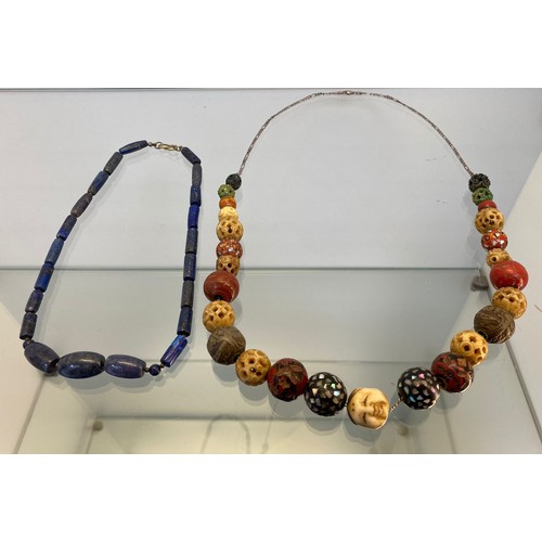 748A - Vintage Oriental bead worked necklace. Designed with an Oni mask carved bead. Together with a lapis ... 