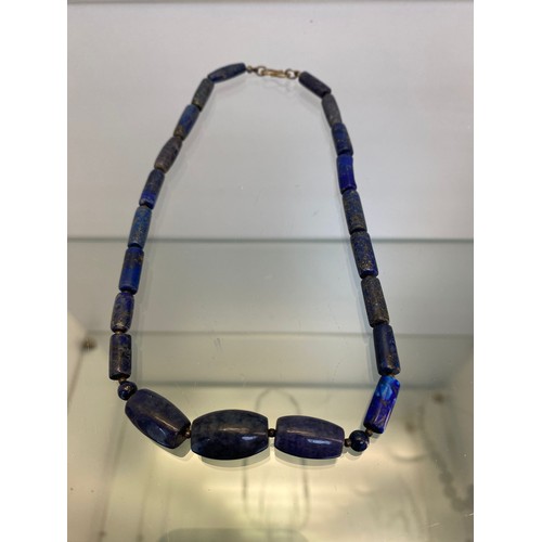 748A - Vintage Oriental bead worked necklace. Designed with an Oni mask carved bead. Together with a lapis ... 