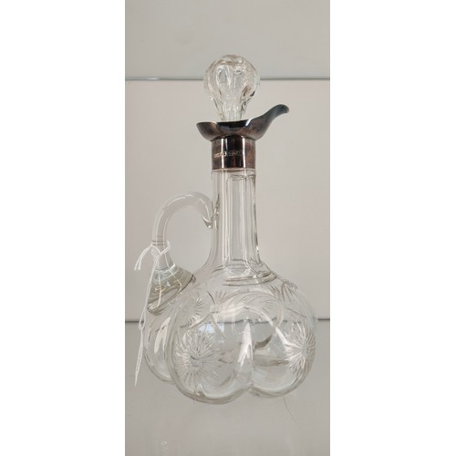 758A - Crystal claret jug fitted with a London silver collar/ pourer and crystal stopper. [22cm high]