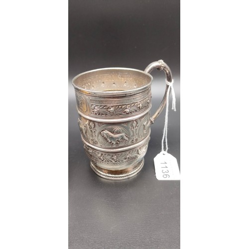 1136 - Victorian Glasgow silver drinking cup with handle; highly decorative showing raised relief African a... 