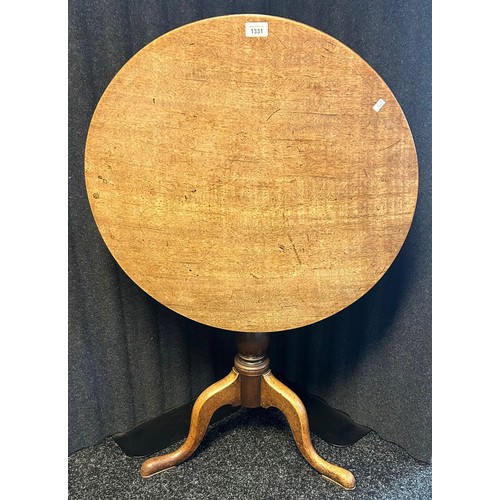 1331 - 19th century tilt top table, the circular surface above a turned pedestal and three cabriole legs [7... 