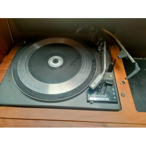 392 - A mid century turn table in fitted teak cabinet fitted with a Ferguson radio