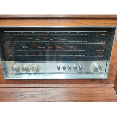 392 - A mid century turn table in fitted teak cabinet fitted with a Ferguson radio