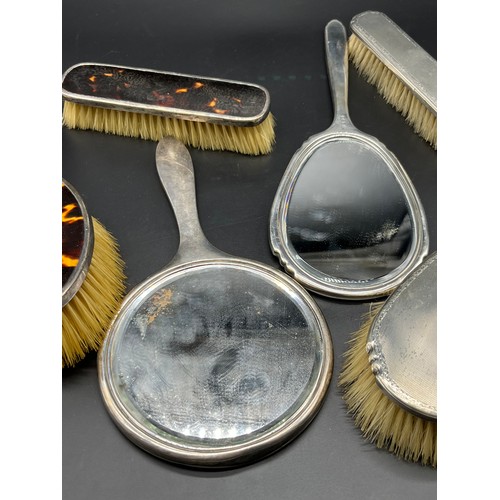 33 - Four Birmingham silver art deco design hand brushes and hand mirror. Together with Three Birmingham ... 