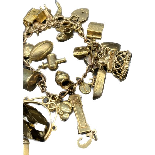 85 - Antique 9ct gold charm bracelet full of various 9ct gold charms; seal charm, swivel fob charm, break... 