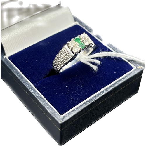 23 - 18ct white gold ring set with white sapphires and green stones. [Ring size L] [5.22Grams]