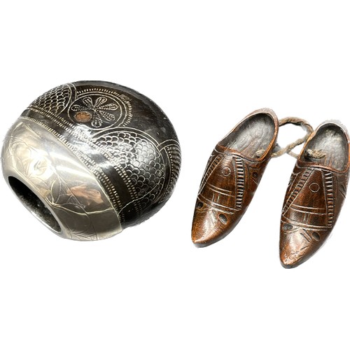 7 - Continental silver mounted nut and a small pair of English carved Treen Shoes. [19th century]