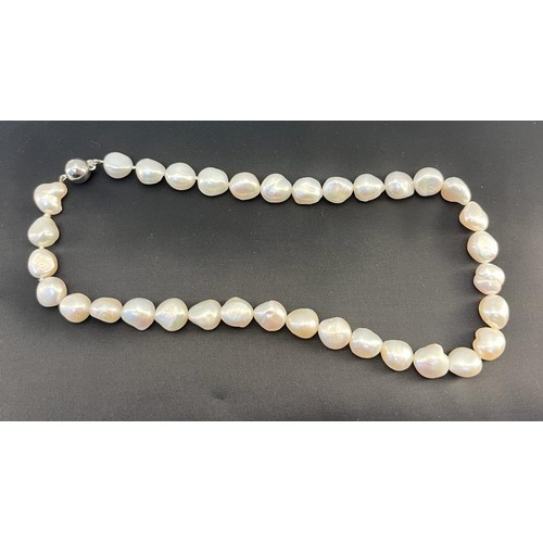 47 - A baroque pearl necklace with a 9ct white gold clasp and catch, Similar necklace with silver clasp a... 