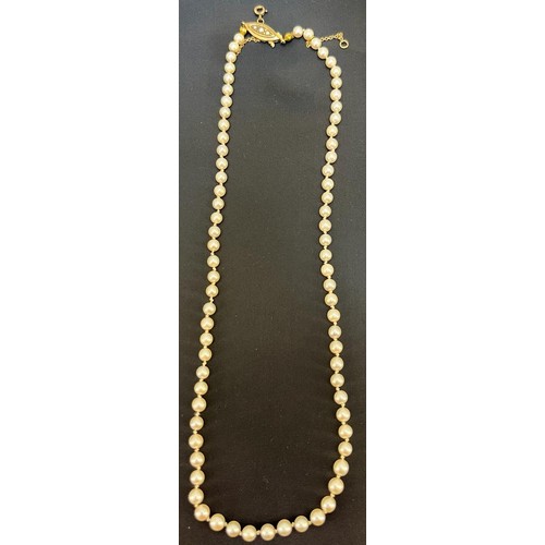 46 - A single strand of cultured pearls
Of even size. 9ct yellow gold and pearl set clasp [Length: 44cm]