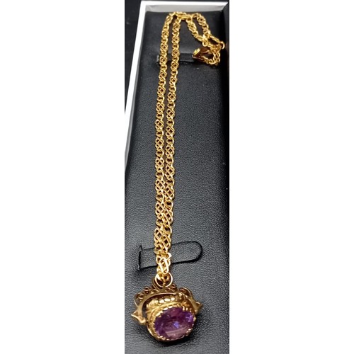 590 - 9ct yellow gold unusual linked necklace fitted with a 9ct three stone swivel fob. [Amethyst, quartz ... 