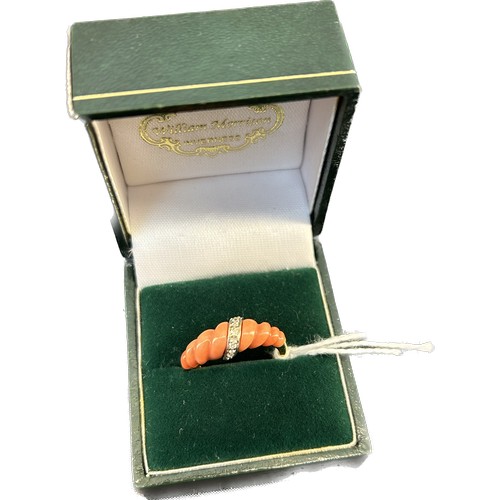 615 - An Italian 18ct gold, diamond, and coral set ring
The ribbed tapering coral with angled band with di... 