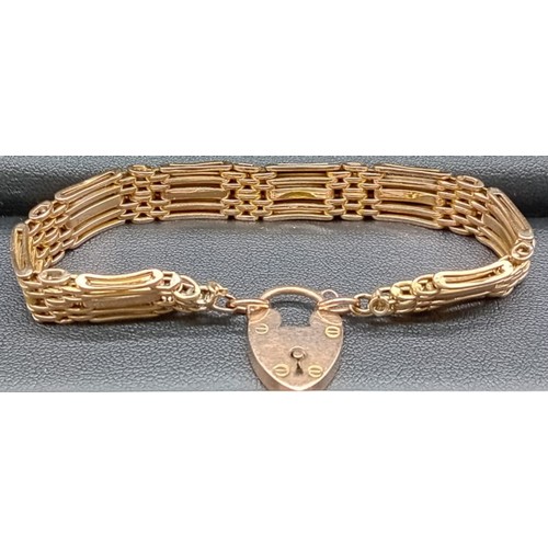 587 - 9ct yellow gold gate bracelet with a heart lock fitted. [16.02grams]