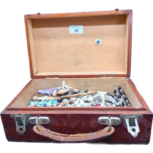 88 - A small case containing a collection of mixed vintage beaded necklaces and various other items