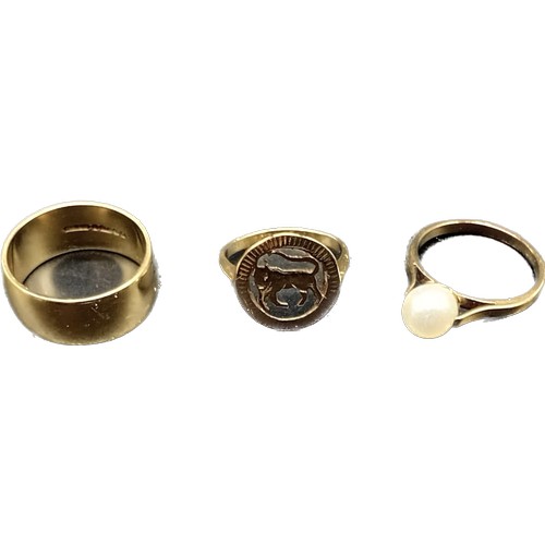 604 - Three various 9ct yellow gold rings; Wedding band, 9ct and pearl ring and one other. [8.99grams]