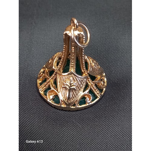 614 - A 9ct gold intaglio fob
The circular green stone carved with a classical armoured head, the gold wor... 