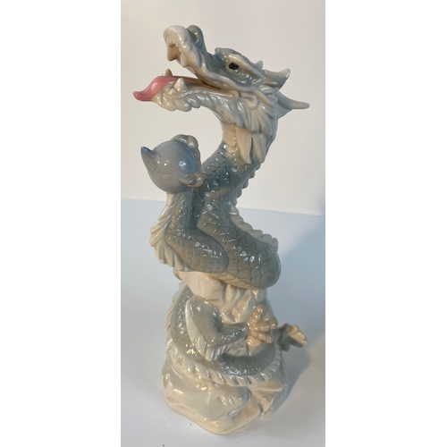 371 - A collection of John Jenkins porcelain dragon figures along with a selection of eastern wooden carve... 