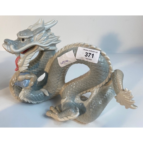 371 - A collection of John Jenkins porcelain dragon figures along with a selection of eastern wooden carve... 