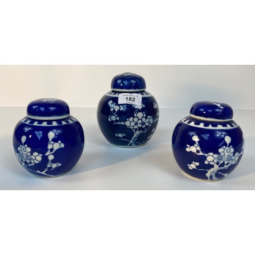 182 - A collection of 3 Chinese lidded prunes ginger jars with covers set in blue background design with f... 