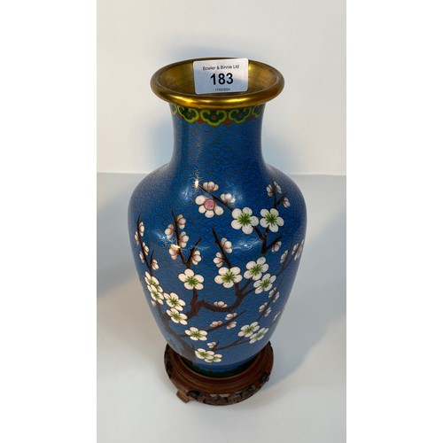 183 - A Pair of cloisonné blue enamelled vases set with tree & bird scene design supported on fruit wood s... 