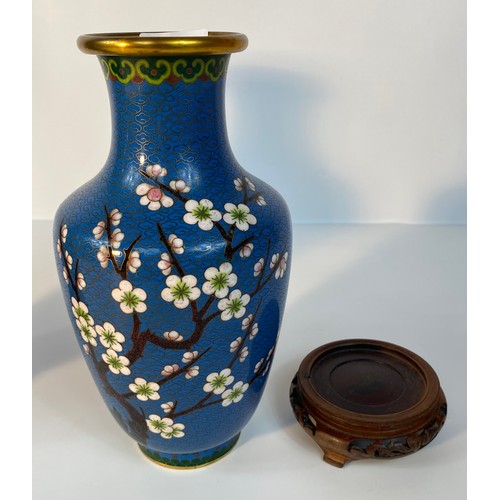 183 - A Pair of cloisonné blue enamelled vases set with tree & bird scene design supported on fruit wood s... 