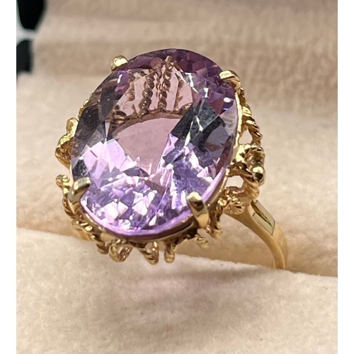 109 - 9ct yellow gold ring set with a large oval amethyst gem stone. [Ring size N] [5.45Grams]