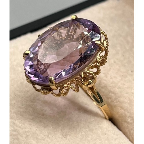 109 - 9ct yellow gold ring set with a large oval amethyst gem stone. [Ring size N] [5.45Grams]