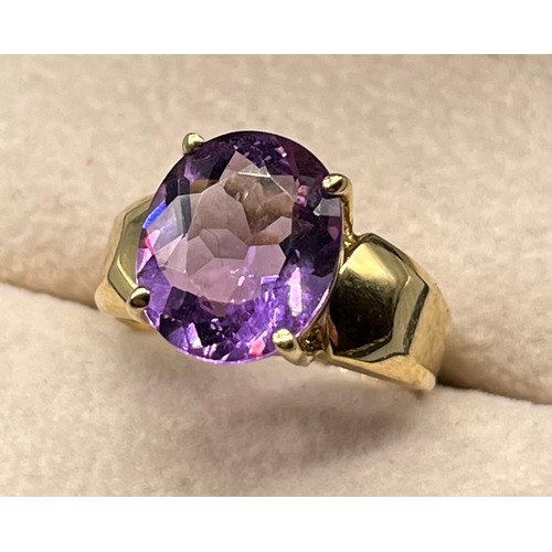 97 - 9ct yellow gold ring set with an oval cut amethyst gem stone. [Ring size M] [4.09Grams]