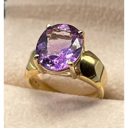 97 - 9ct yellow gold ring set with an oval cut amethyst gem stone. [Ring size M] [4.09Grams]