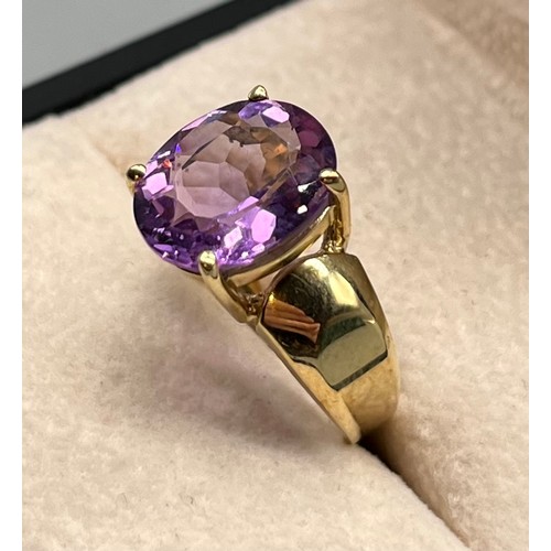 97 - 9ct yellow gold ring set with an oval cut amethyst gem stone. [Ring size M] [4.09Grams]