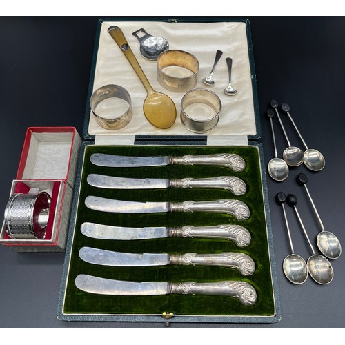 13 - A Collection of silver items; Four silver napkin rings [83.35grams], Silver and horn porridge spoon,... 