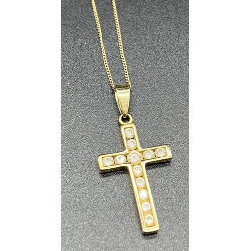 17 - 9ct yellow gold and round cut stone cross pendant together with a 9ct gold chain. [2.51grams]