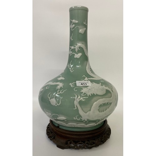 411 - A CHINESE CELADON-GLAZED SLIP-DECORATED 'DRAGON' VASE. Qing Dynasty, 19th Century. Decorated with tw... 