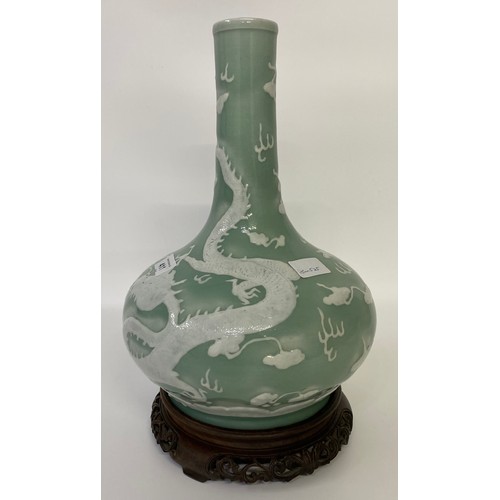 411 - A CHINESE CELADON-GLAZED SLIP-DECORATED 'DRAGON' VASE. Qing Dynasty, 19th Century. Decorated with tw... 