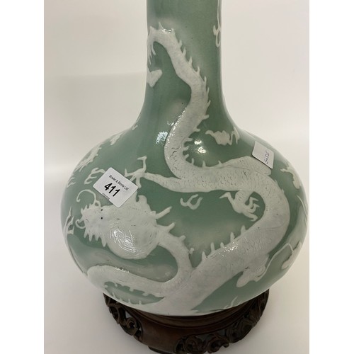 411 - A CHINESE CELADON-GLAZED SLIP-DECORATED 'DRAGON' VASE. Qing Dynasty, 19th Century. Decorated with tw... 