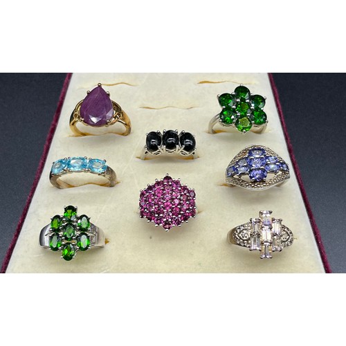 100 - A Lot of eight 925 silver and gem stone rings; Blue topaz, tourmaline and amethyst.