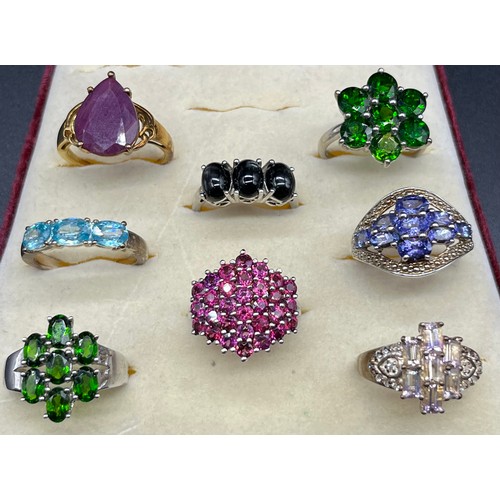 100 - A Lot of eight 925 silver and gem stone rings; Blue topaz, tourmaline and amethyst.