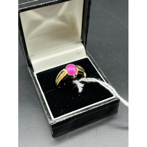 111 - 9ct yellow gold ring set with a pink cabochon gem stone [Ring size N] [3.85Grams]