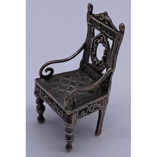 16 - A cast Chinese 19 th century miniature model
of an ornate Elizabethan inspired armchair,
carved back... 