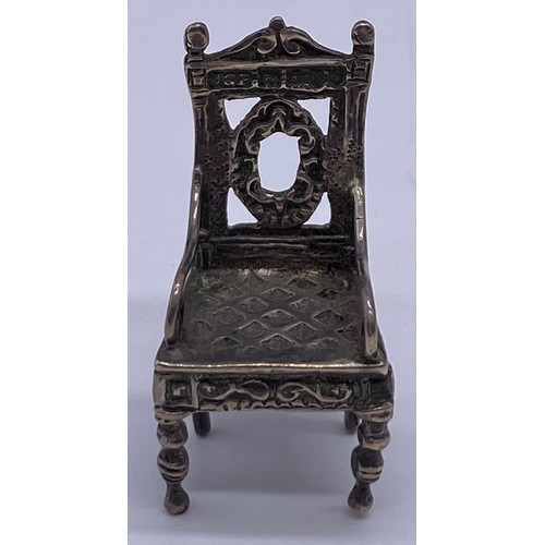 16 - A cast Chinese 19 th century miniature model
of an ornate Elizabethan inspired armchair,
carved back... 