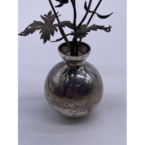 19 - A small silver vase of flowers
Pauline Dury/Gainsbury, London 1988, the
vase of spherical form, flar... 