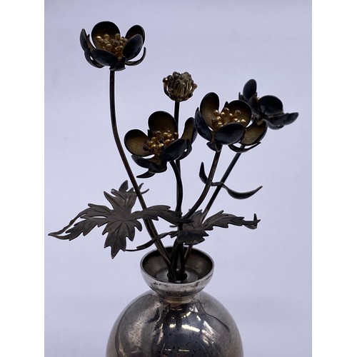 19 - A small silver vase of flowers
Pauline Dury/Gainsbury, London 1988, the
vase of spherical form, flar... 