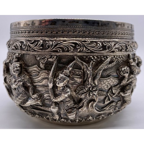 24 - A mid-19 th century Burmese silver bowl
Unmarked, all-over decoration of band of
figures
Diameter: 1... 