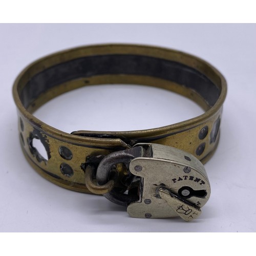 27 - A mid-19 th century brass and steel pet collar
Steel band in a pierced brass sleeve,
engraved Freder... 