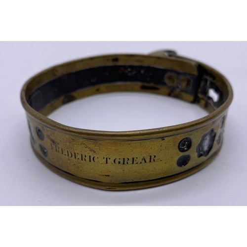 27 - A mid-19 th century brass and steel pet collar
Steel band in a pierced brass sleeve,
engraved Freder... 