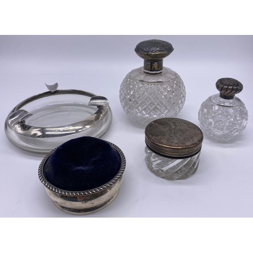 42 - Silver hallmarked pin cushion, Birmingham silver collared ashtray and a selection of silver topped g... 