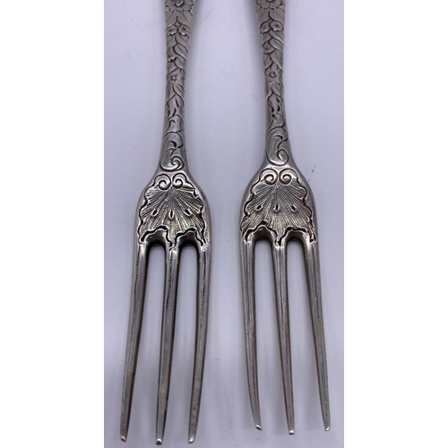 68 - Pair of three prong forks Circa 1750, boldly later decorated with chased foliage to the stems and ‘G... 